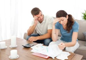Worried couple doing their accounts in the living room — Overland Park, KS — Wiesner & Frackowiak LC